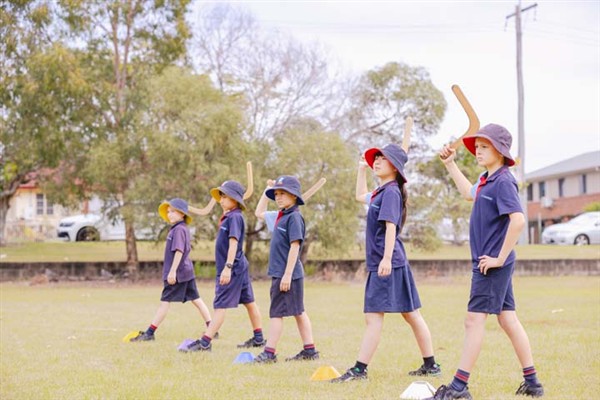 Five students getting ready to throw boomerangs