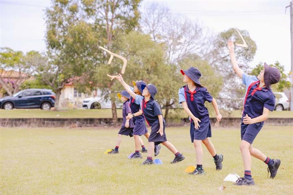 Students learning to throw boomerangs.