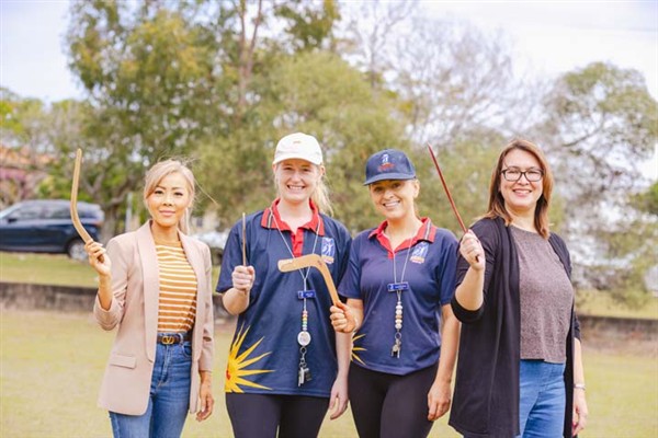 Staff and parents participating in boomerang throwing 