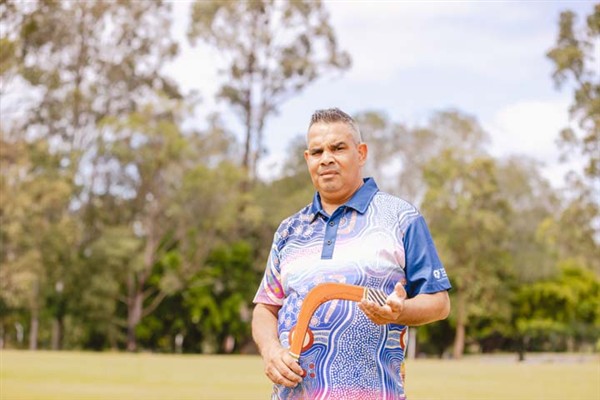 Cultural Tutor, Marlon Riley holding a boomerang
