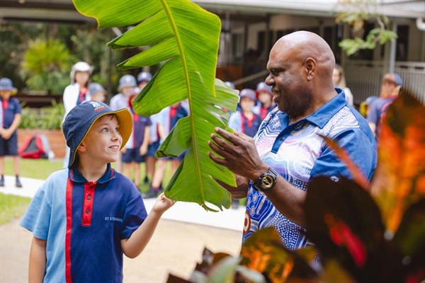 Cultural Tutor Brian Whap sharing a plants different uses to a student