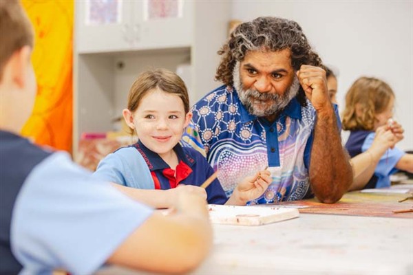 Cultural Tutor Robert Duncan with school students painting