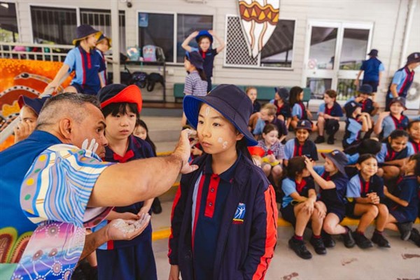 A student receiving ceremonial face painting