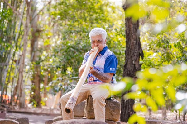 Tutor Eric Ellis playing a Digeridoo