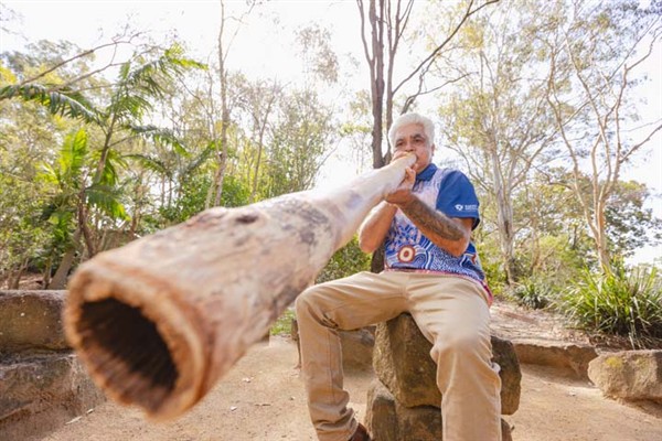 Cultural Tutor Eric Ellis playing a Digeridoo